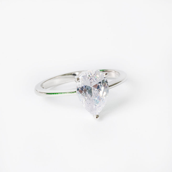 Melissa ring featuring a single cubic zirconia gemstone surrounded by smaller clear crystals, set in a hypoallergenic band.