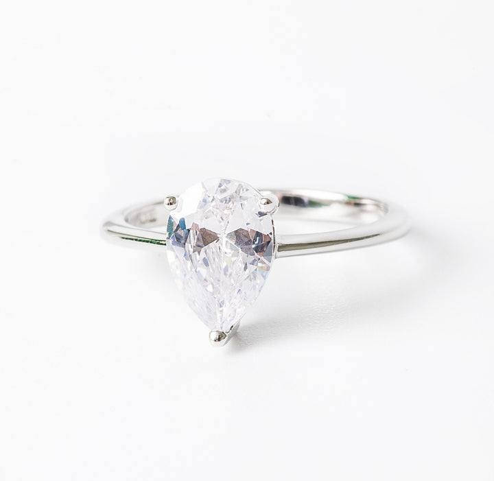 Melissa ring featuring a single cubic zirconia gemstone surrounded by smaller clear crystals, set in a hypoallergenic band.