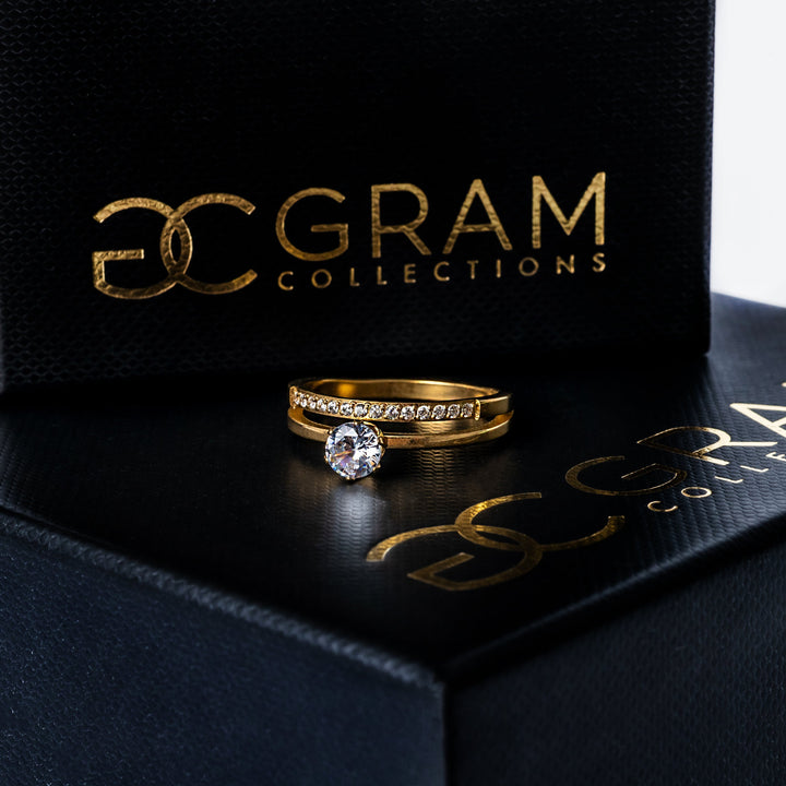 A Michela Gold Ring standing in the center of the image against a white background. 