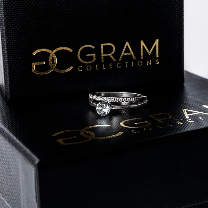 Michela Silver Ring placed on its box standing in the center of the image 