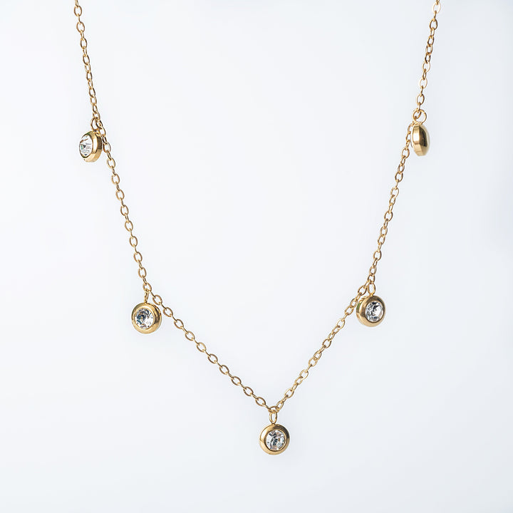 Gold Mirielle necklace with bezel set dangling clear crystals