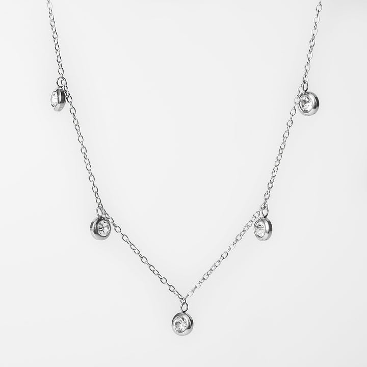 Silver Mirielle necklace with bezel set dangling crystals on a delicate chain