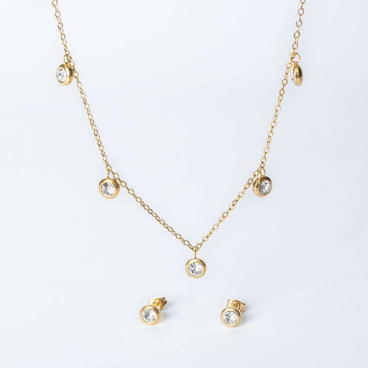 Gold Mirielle jewelry set with a dangling crystal necklace and matching crystal stud earrings