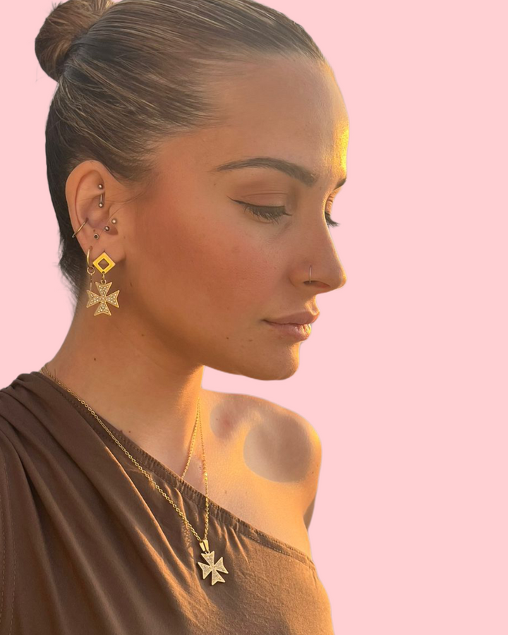 A profile view of a woman wearing Cross  of the order Necklace. 