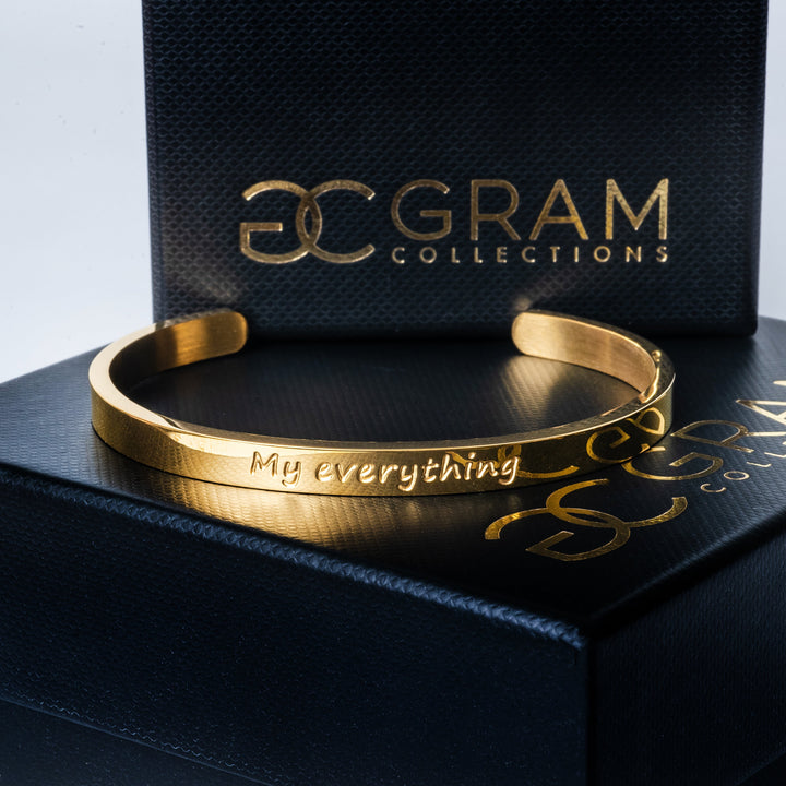 My Everything Bracelet placed on its uniquely designed black box with a Gram logo in the center of the box. 