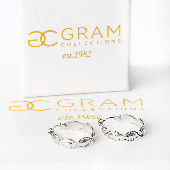 Nikita silver earrings placed on top of its uniquely designed Gram Collections box. 
