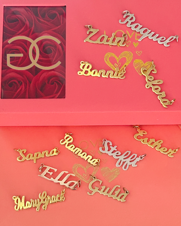 A collection of name necklaces in gold, rose gold, and silver colors, with various names such as Zah, Rag, Bonni, and more, displayed against a pink background with a red rose emblem.