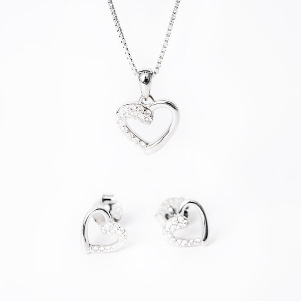 A sterling silver jewelry set including a pendant, chain, and earrings, adorned with cubic zirconia.