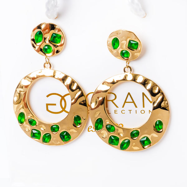 A pair of gold-plated stainless steel earrings with green cubic zirconia accents, displayed against a white background.