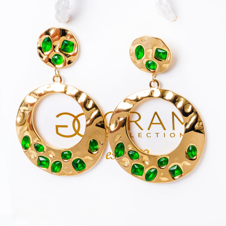 A pair of gold-plated stainless steel earrings with green cubic zirconia accents, displayed against a white background.