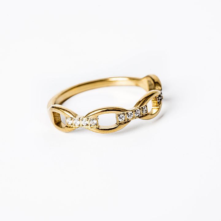 Pamela Gold Ring standing in the center in the image against a white background.