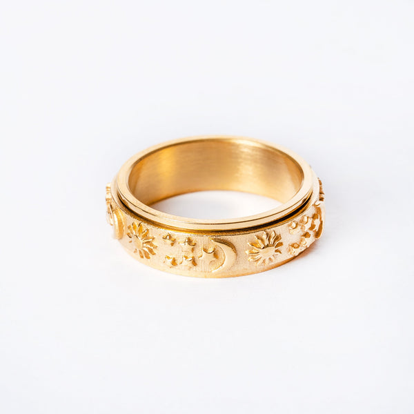A gold-plated stainless steel ring with floral patterns on the band.