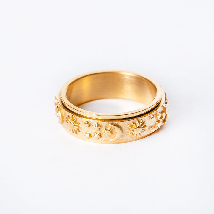 A gold-plated stainless steel ring with floral patterns on the band.