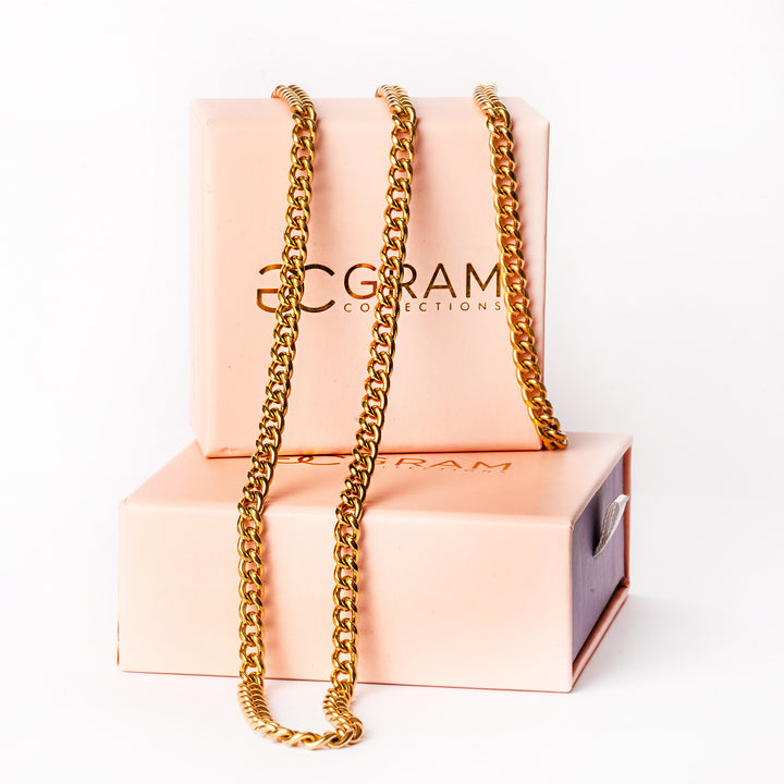 A close up view of Parma Gold Bracelet placed on its box, standing in the center of the image against a white background. 