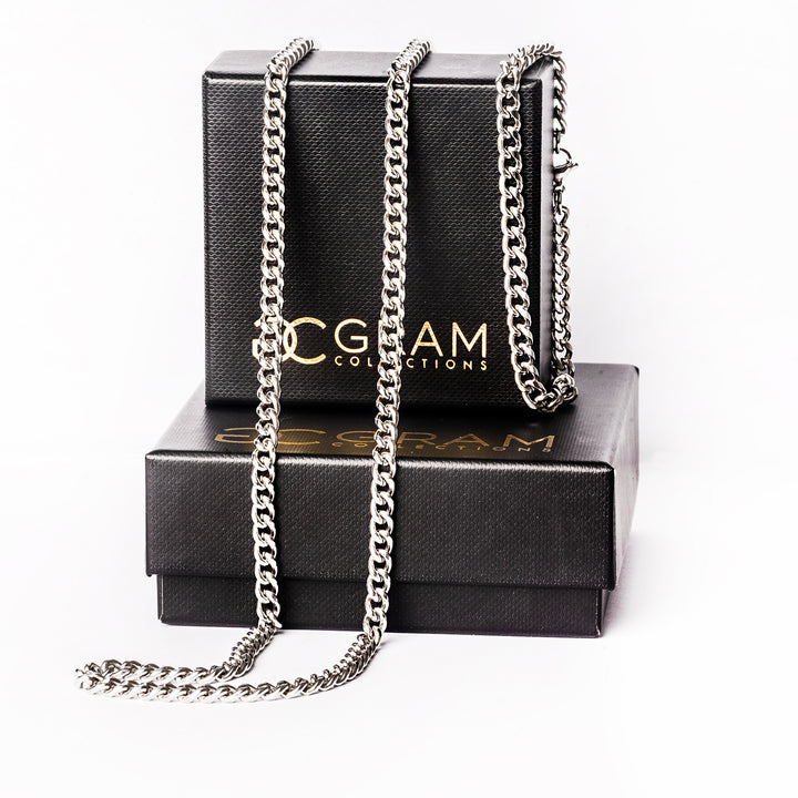 Parma silver necklace standing in the center of the image placed on its box surrounded by a white background. 