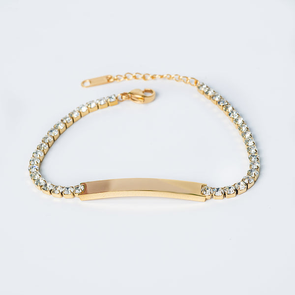 Gold Pataya bracelet with clear stones and a curved gold bar in the center