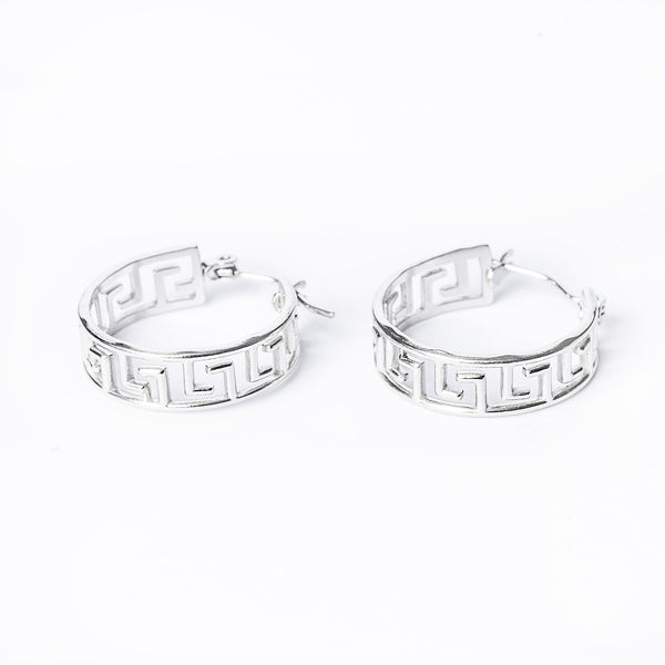 a close up view of paulette silver earrings standing in the center of the image against a white background. 
