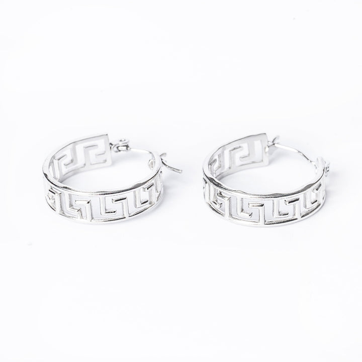 a close up view of paulette silver earrings standing in the center of the image against a white background. 