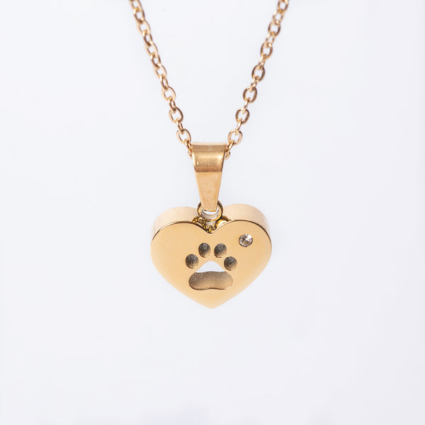 A yellow gold paw necklace with a stainless steel pendant in the shape of a heart with a paw print on it.