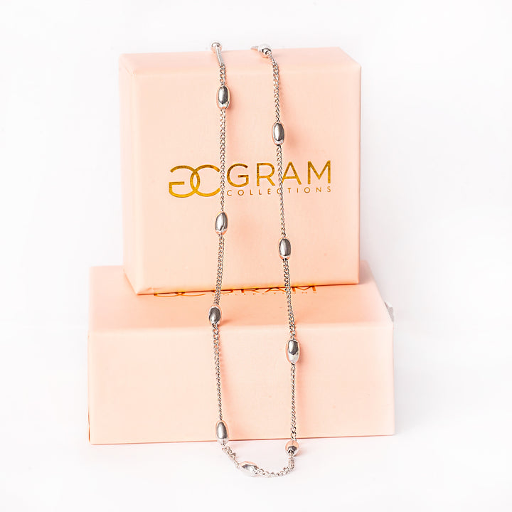 A close up view of necklace standing in the center of the image against a white background 