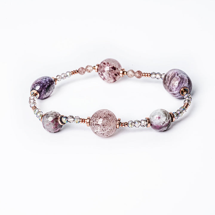 A plum bracelet with a combination of purple and pink stones, gold-plated stainless steel band, and glass beads.