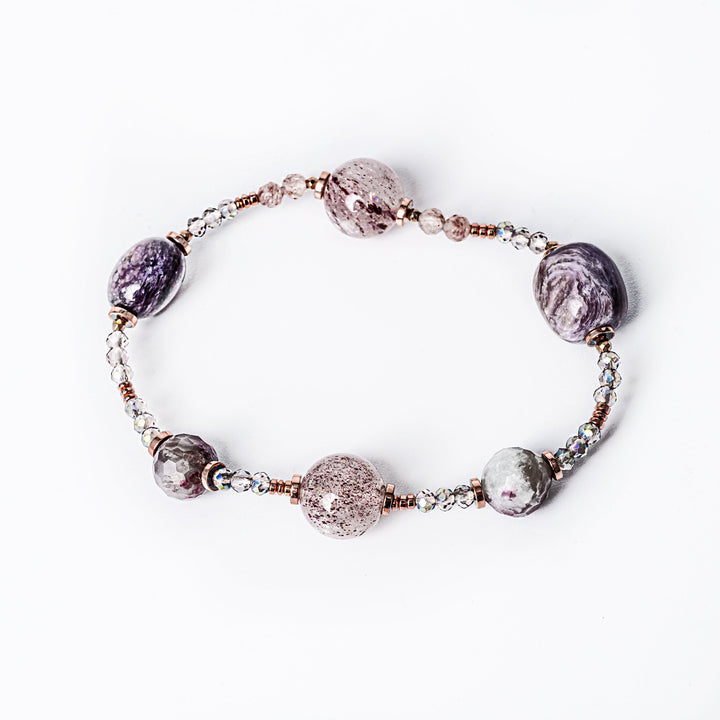 A plum bracelet standing in the center of the image against a white background. 