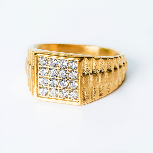 A yellow gold banded President ring with a series of AAA cubic zirconia stones set in a geometric pattern.