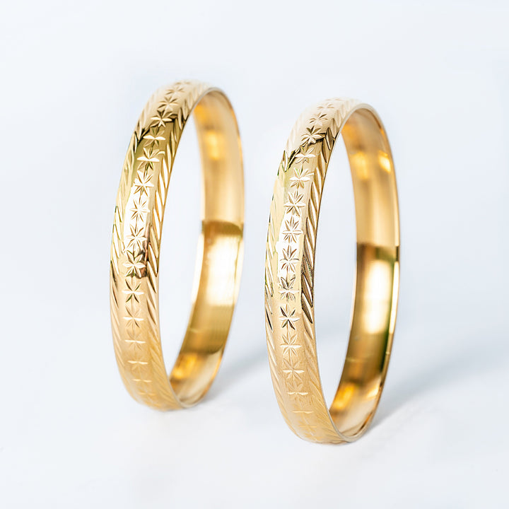 Profile view of Maltese Fili (pair) standing in the center of the image against a white background. 