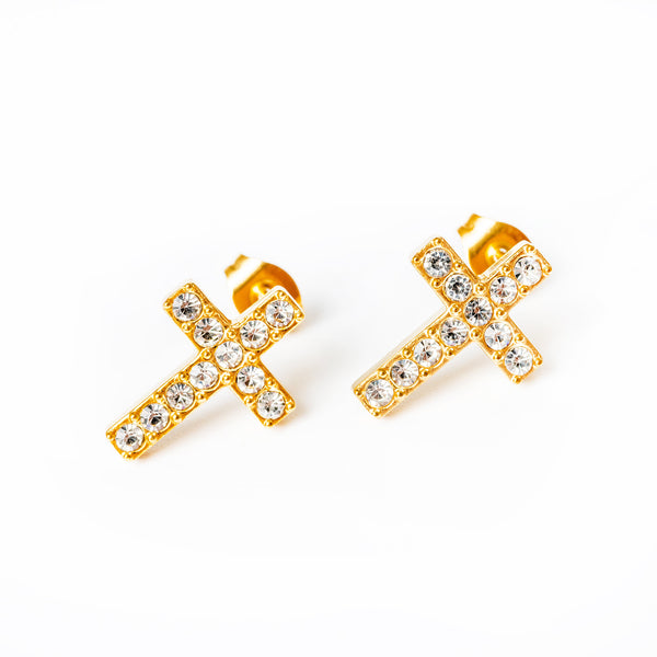 A pair of gold-plated.cross-shaped yellow gold Raisa earrings adorned with AAA cubic zirconia gems in a cross pattern.
