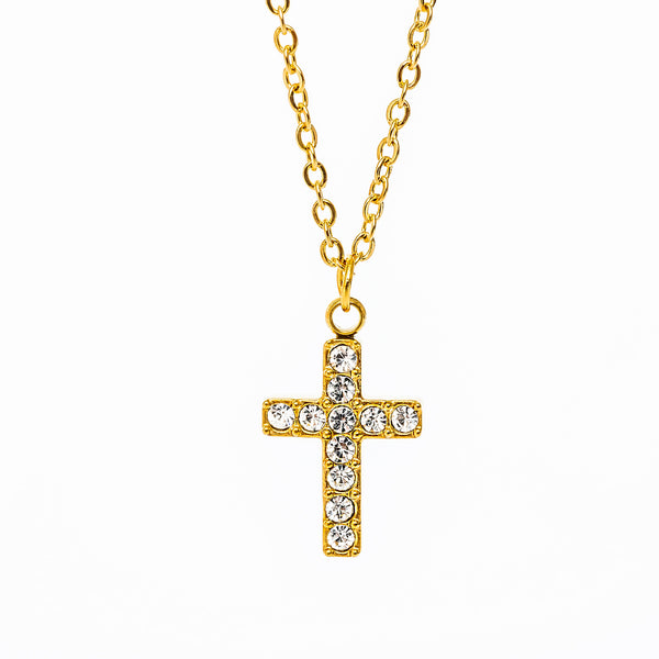 A gold-plated Raisa necklace with a yellow gold chain and a clear, AAA cubic zirconia pendant in the shape of a cross.