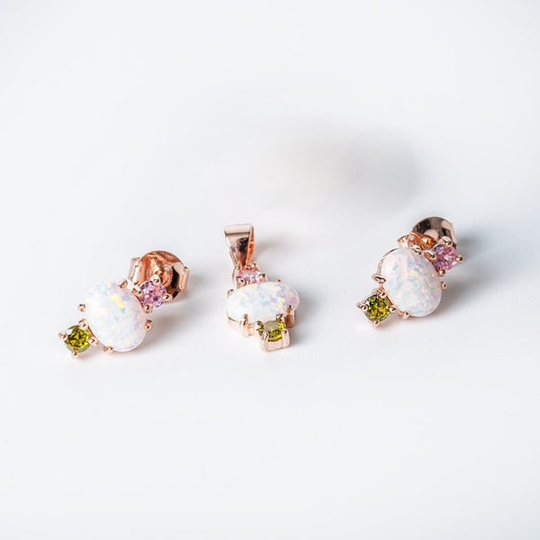 A Ren set of sterling silver jewelry including a pendant and earrings with rose gold plating, adorned with multicolored cubic zirconia stones.