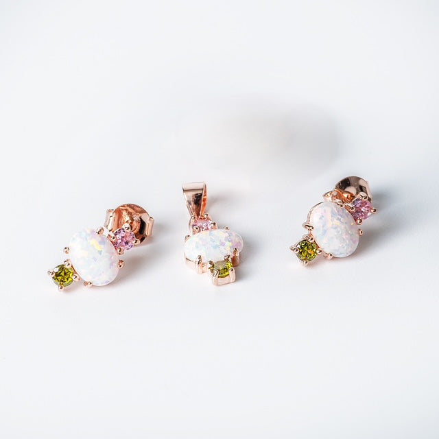 A Ren set of sterling silver jewelry including a pendant and earrings with rose gold plating, adorned with multicolored cubic zirconia stones.