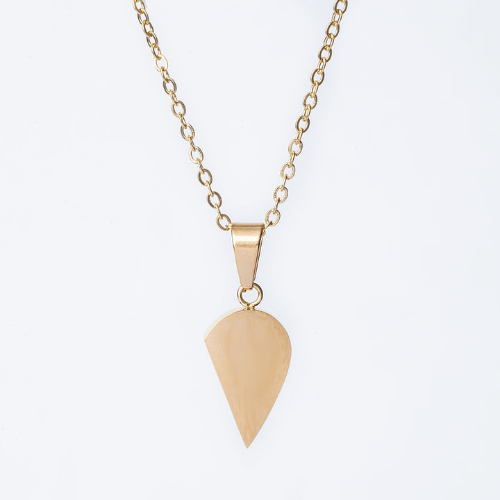 The right side of a broken heath pendant, attached to its chain, standing against a white background. 