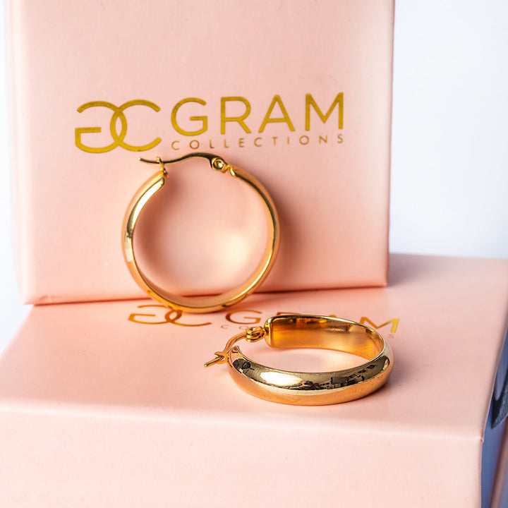 A close up view of Ritianne Earrings placed on its uniquely designed pink box with Gram collection logo on it.