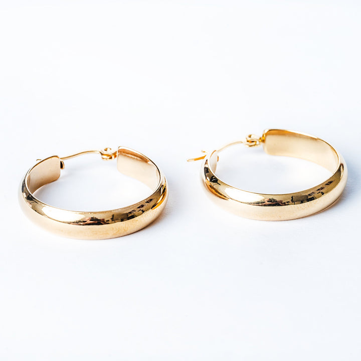 A close up view of Ritianne Earrings standing in the center of the image against a white background. 