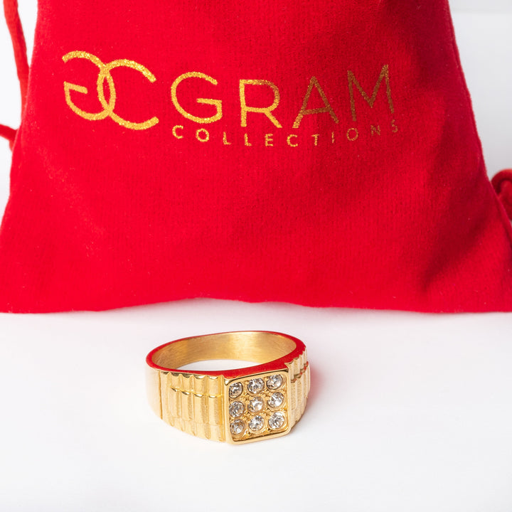 A close up view of Rolex ring standing in center of its red package. 