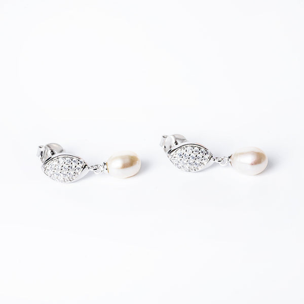 A close up view of Romy Earrings standing in the center of the image. 