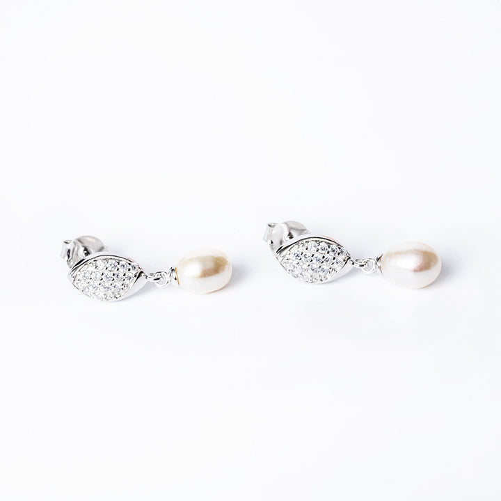 A close up view of Romy Earrings standing in the center of the image. 