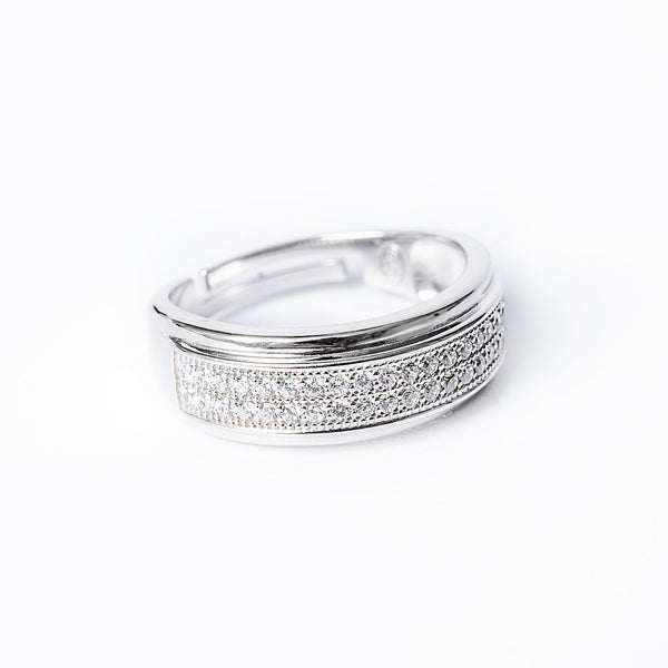 A silver ring with a band of cubic zirconia stones set around its circumference.