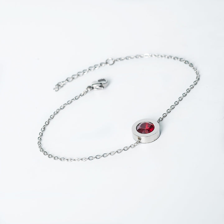 Silver Rosaria bracelet with a red oval gemstone in a bezel setting