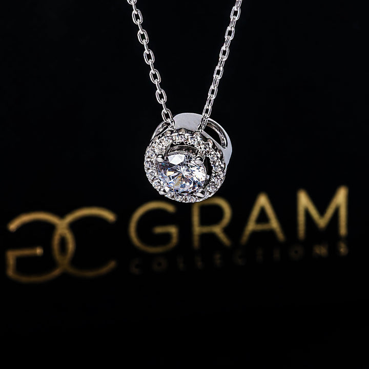 Roise necklace placed in the center of the image against its uniquely designed box 