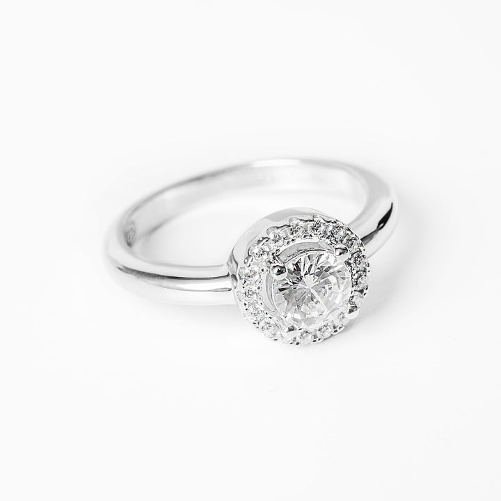 A silver Rosie ring close up profile view, standing in the center of the image against a white background. 