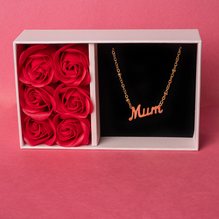 A wide view of Rosina mum necklace standing against a red background. 