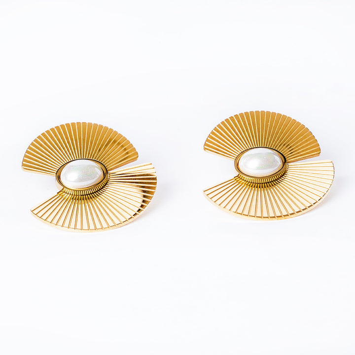 Ruby earrings stand next to each other in the center of the image surrounded by a white background. 