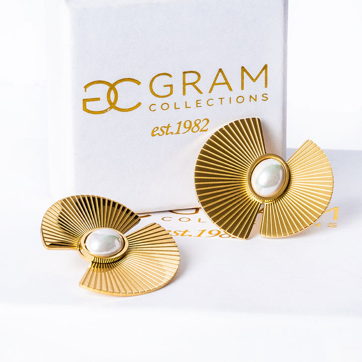 Ruby Earrings standing in front of their uniquely designed white box. 