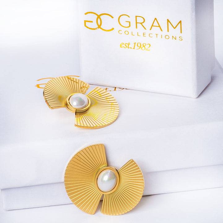 Ruby earrings placed on their uniquely designed box standing in the center of the image. 