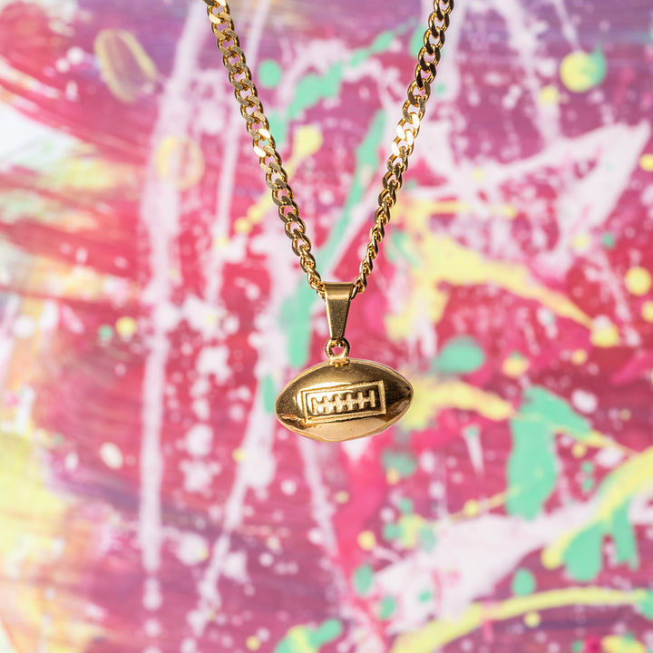 Rugby Necklace standing in front of colorful background, made out of red, yellow, and green colour. 