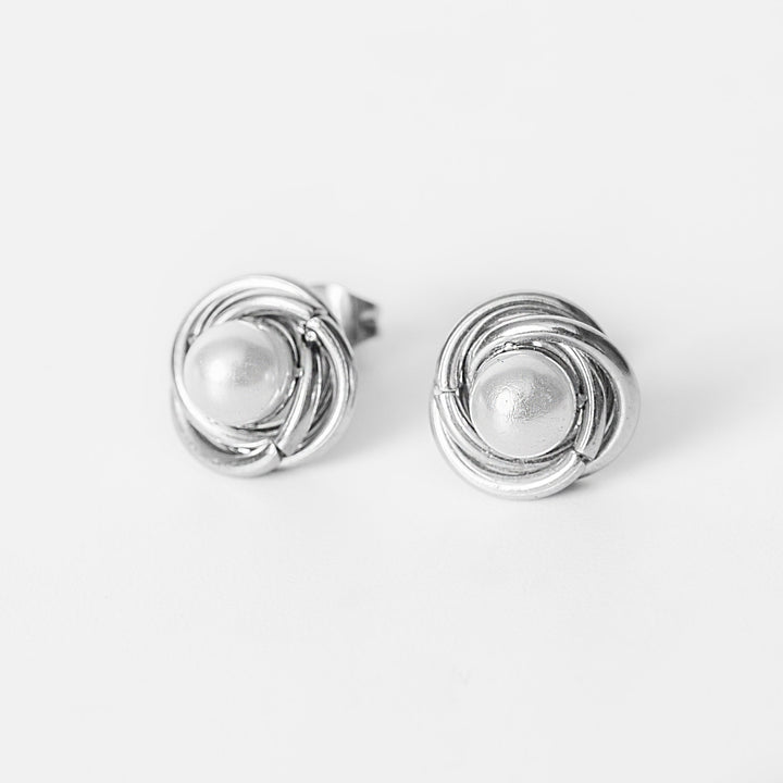 Ruth silver stud earrings with wrapped pearl design in front view