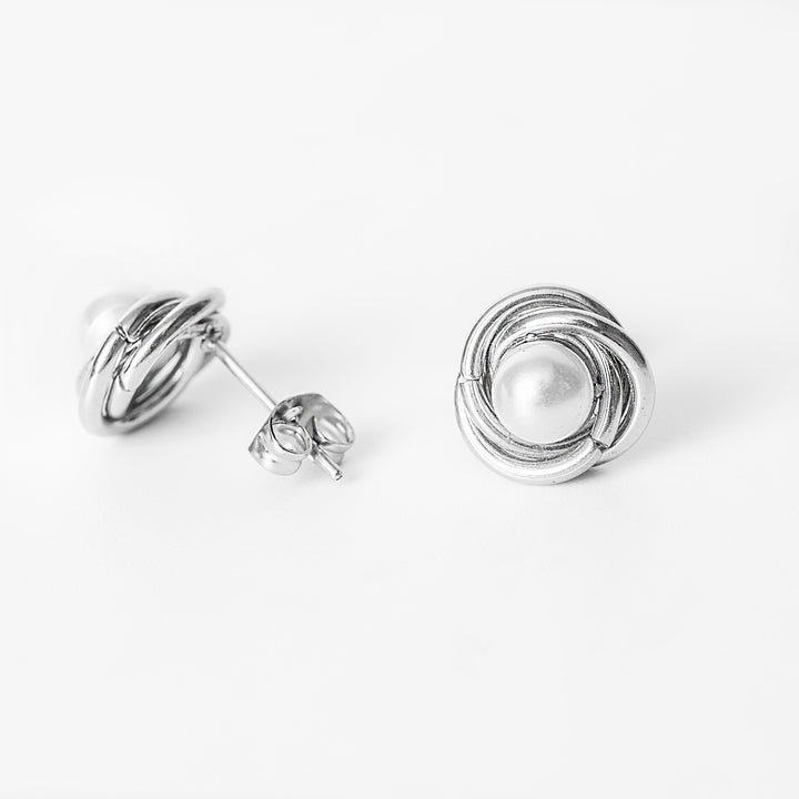 Ruth silver stud earrings with wrapped pearl design in side view