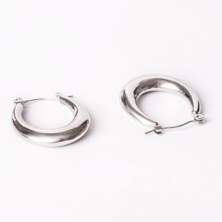 Sandra Silver Earrings standing in the center of the image against a white background